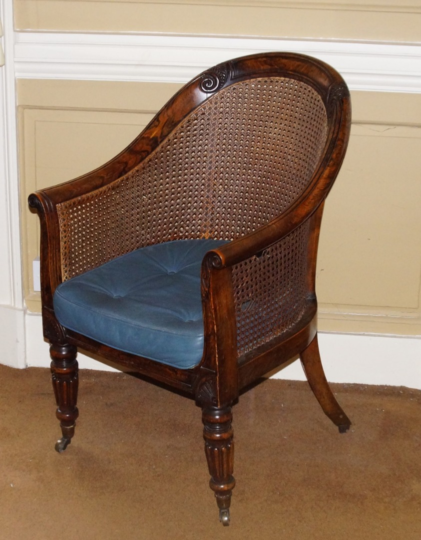 Appraisal: A George IV simulated rosewood bergere chair the frame carved