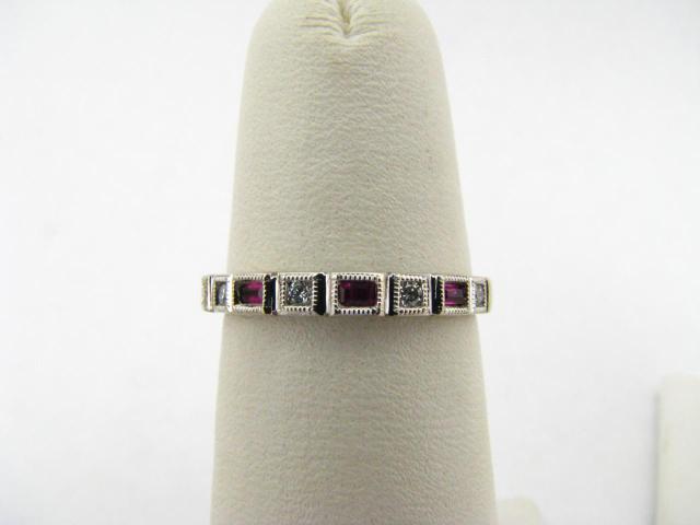 Appraisal: K white gold lady's band with three small rectangular rubies