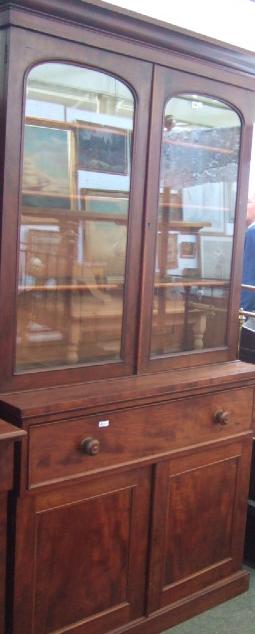 Appraisal: A Victorian mahogany cupboard bookcase the pierced and scroll mounted