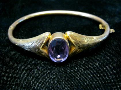 Appraisal: karat yellow gold amethyst bangle braceletLarge oval cut amethyst