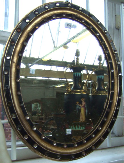 Appraisal: A th century silvered and ebonised Irish mirror of oval