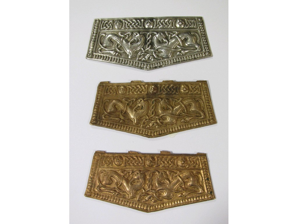 Appraisal: Three embossed copper sporran mantles with entwined beats beneath a