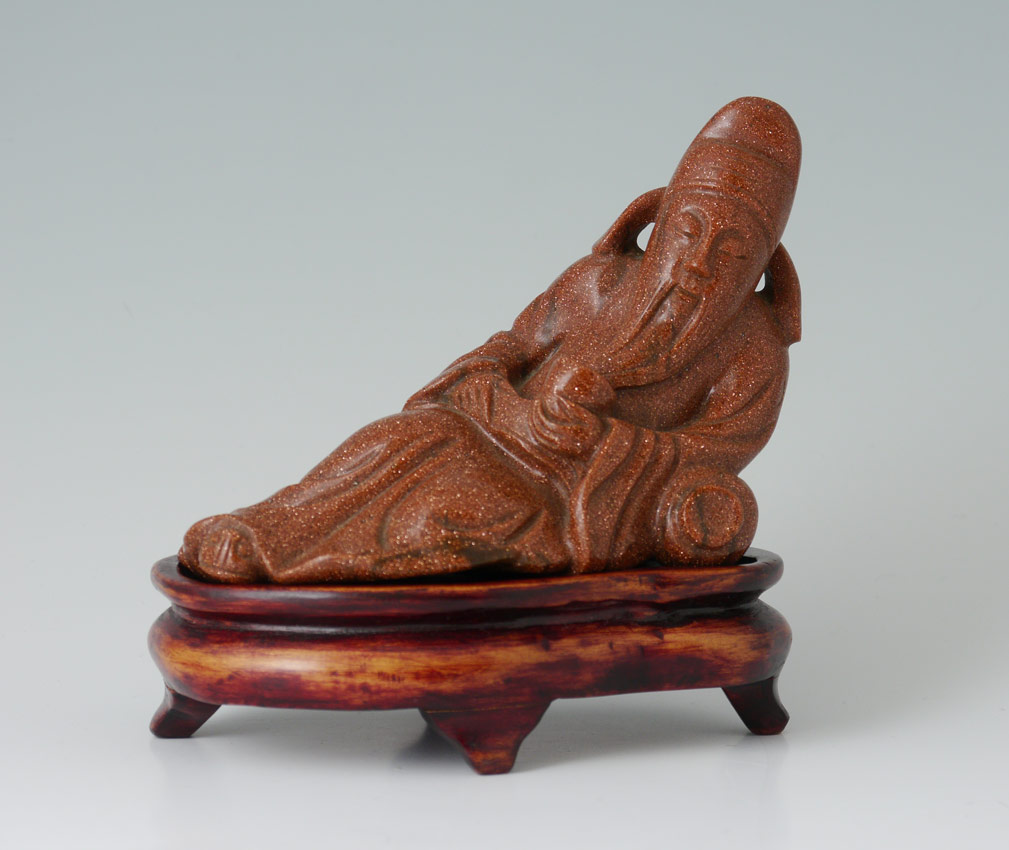 Appraisal: ORIENTAL CARVED GOLDSTONE ELDER FIGURE Figure of a reclining elder