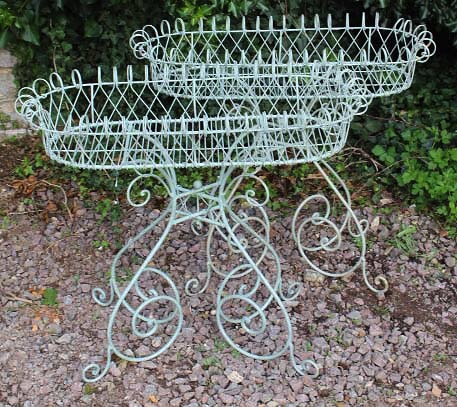 Appraisal: A PAIR OF GREEN PAINTED WIREWORK CONSERVATORY PLANT STANDS with