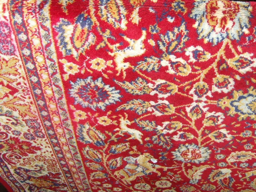 Appraisal: A large red ground wool carpet in the Persian style