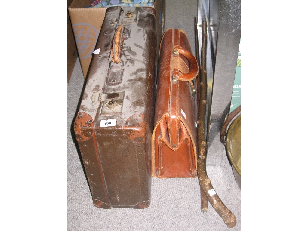 Appraisal: Lot comprising a suitcase leather satchel two walking sticks