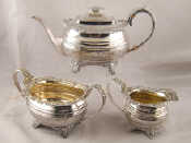 Appraisal: A three piece Georgian silver barge shaped teaset on acanthus