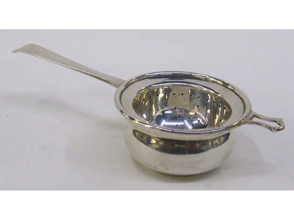 Appraisal: Silver tea strainer in stand London