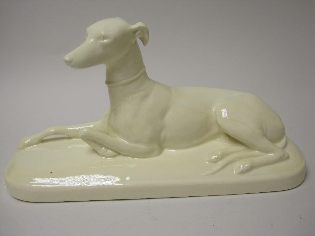 Appraisal: A Sarreguemines white pottery Figure of a seated greyhound in