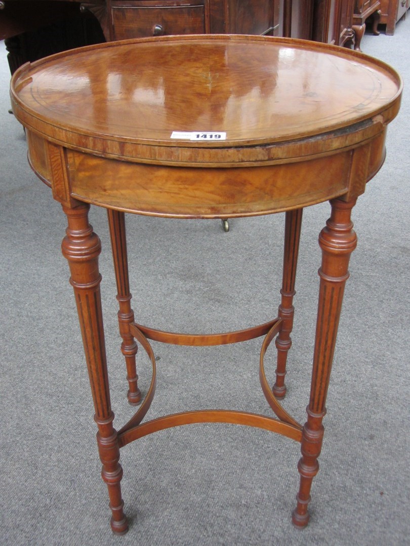 Appraisal: A late th century satinwood circular occasional table on fluted