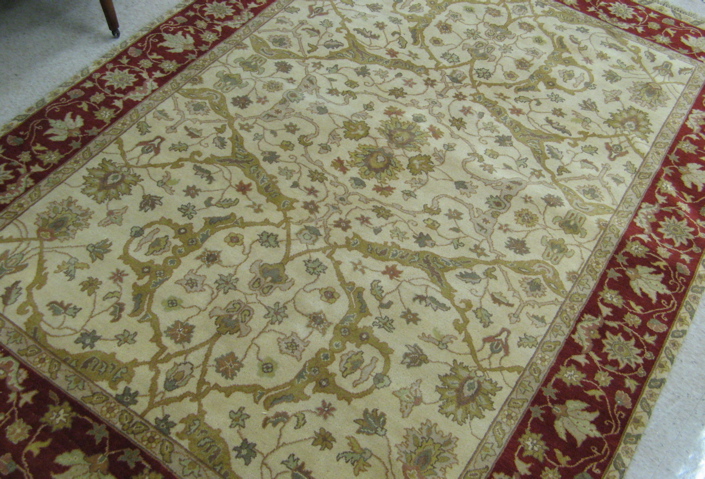 Appraisal: HAND KNOTTED ORIENTAL CARPET Indo-Persian overall floral decoration on cream