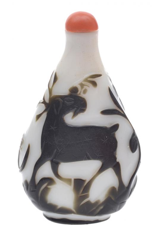 Appraisal: A BLACK GLASS OVERLAY SNUFF BOTTLE WITH CORAL STOPPER