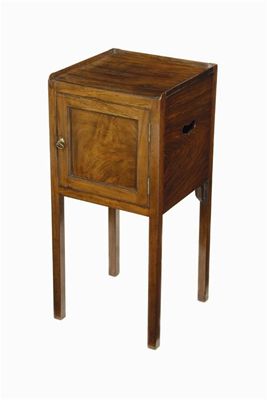 Appraisal: A mahogany pot cupboard the sides with pierced handgrips in