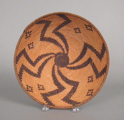 Appraisal: Apache coiled basketry bowl ca with pinwheel design radiating from