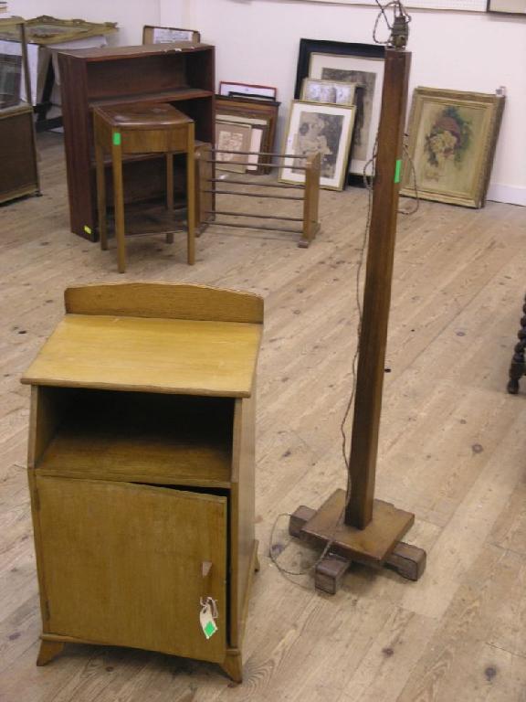 Appraisal: A solid light oak bedside cupboard with recess together with