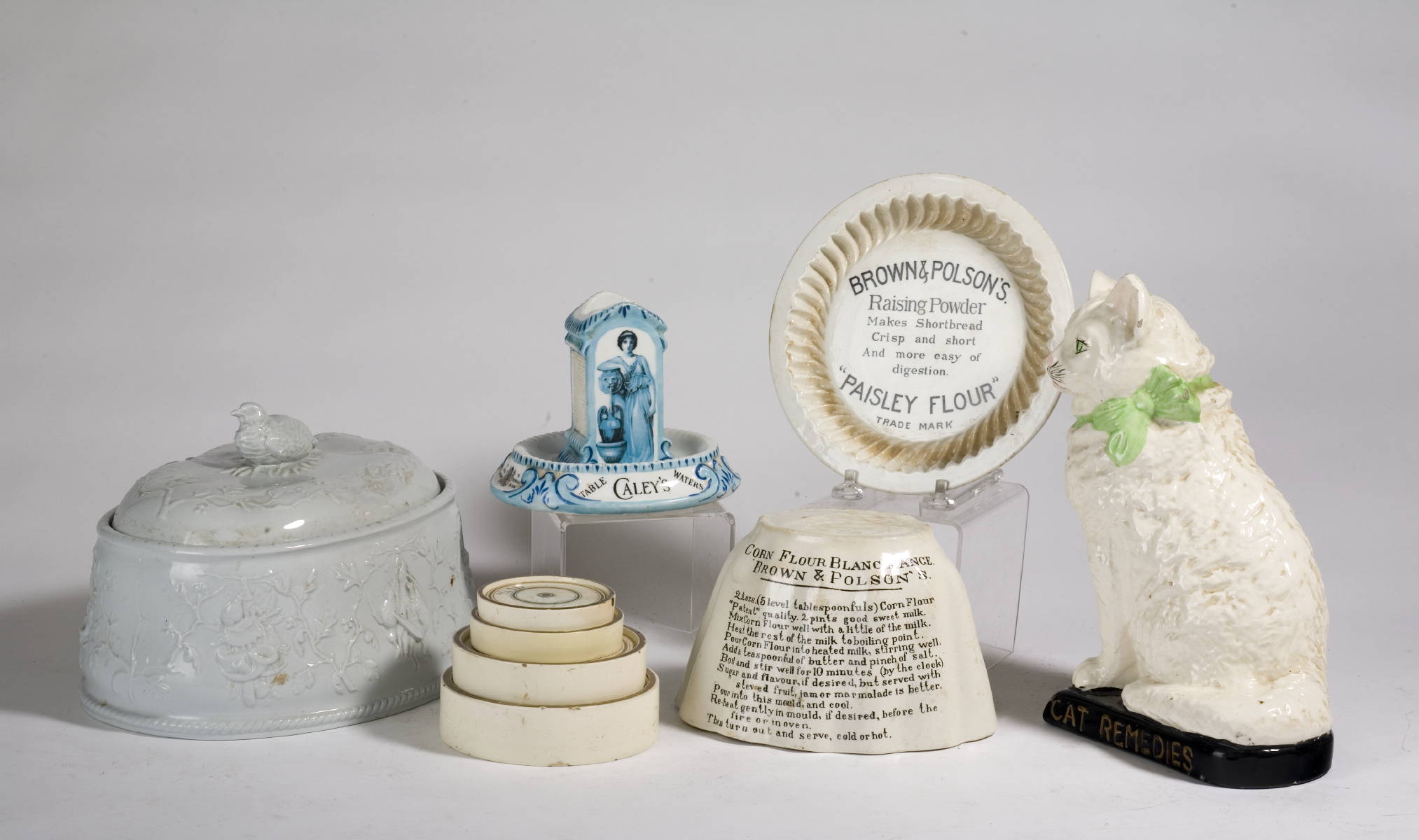 Appraisal: ENGLISH POTTERY ADVERTISING TABLEWARES INCLUDING A CAT A FOOD MOLD