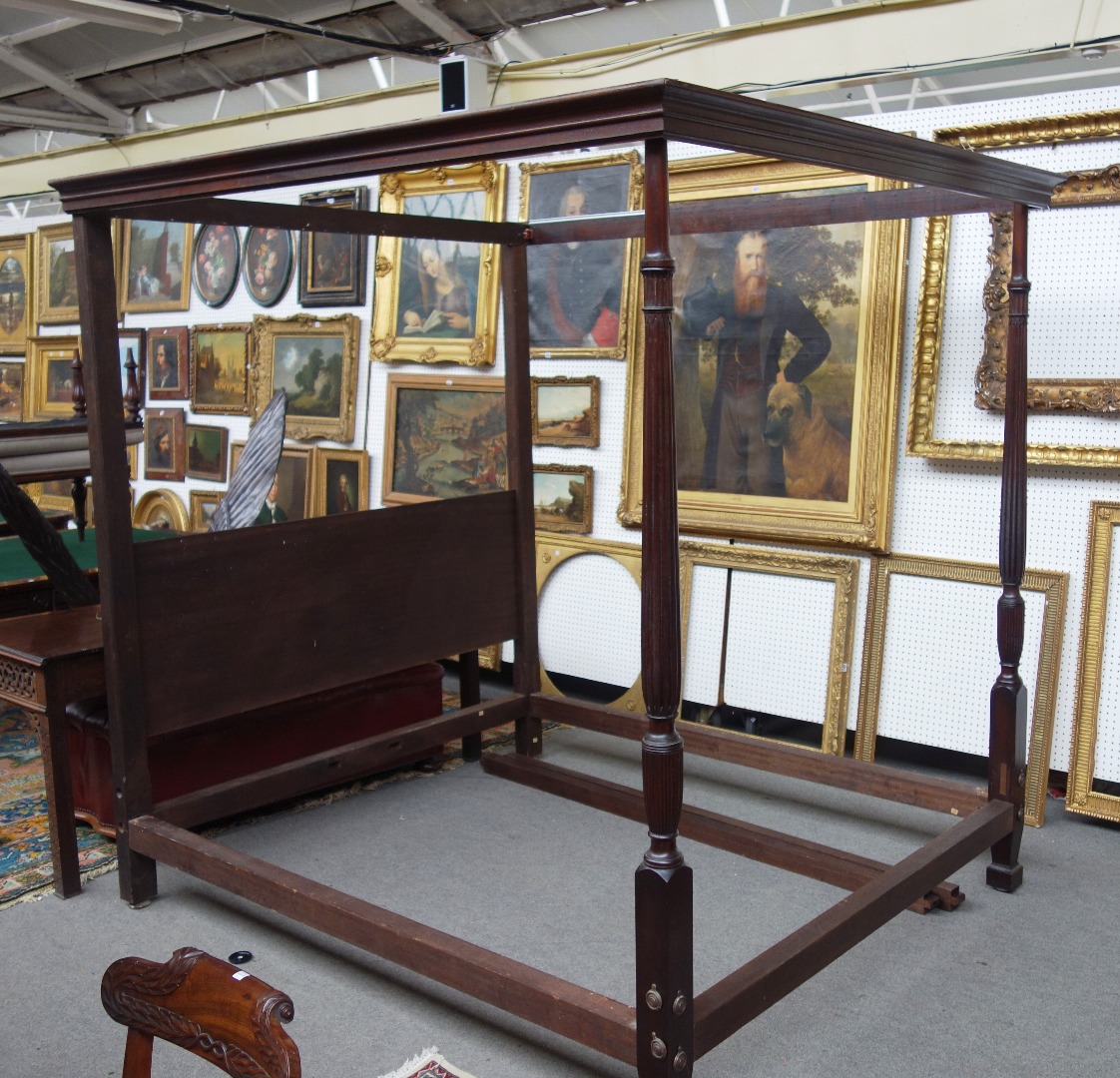 Appraisal: A George III style mahogany four poster bed with reeded