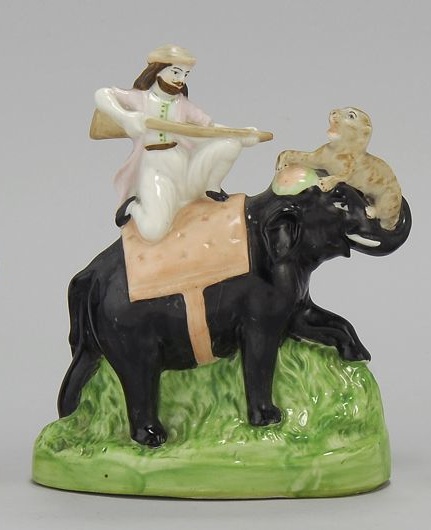 Appraisal: STAFFORDSHIRE FIGURE GROUP th CenturyIndian hunter and lion cub on