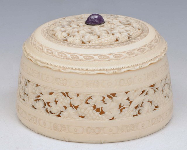 Appraisal: A CARVED IVORY OVAL BOX and cover with hardstone finial