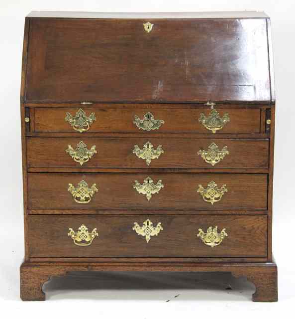 Appraisal: A George III oak bureau circa with hinged fall and