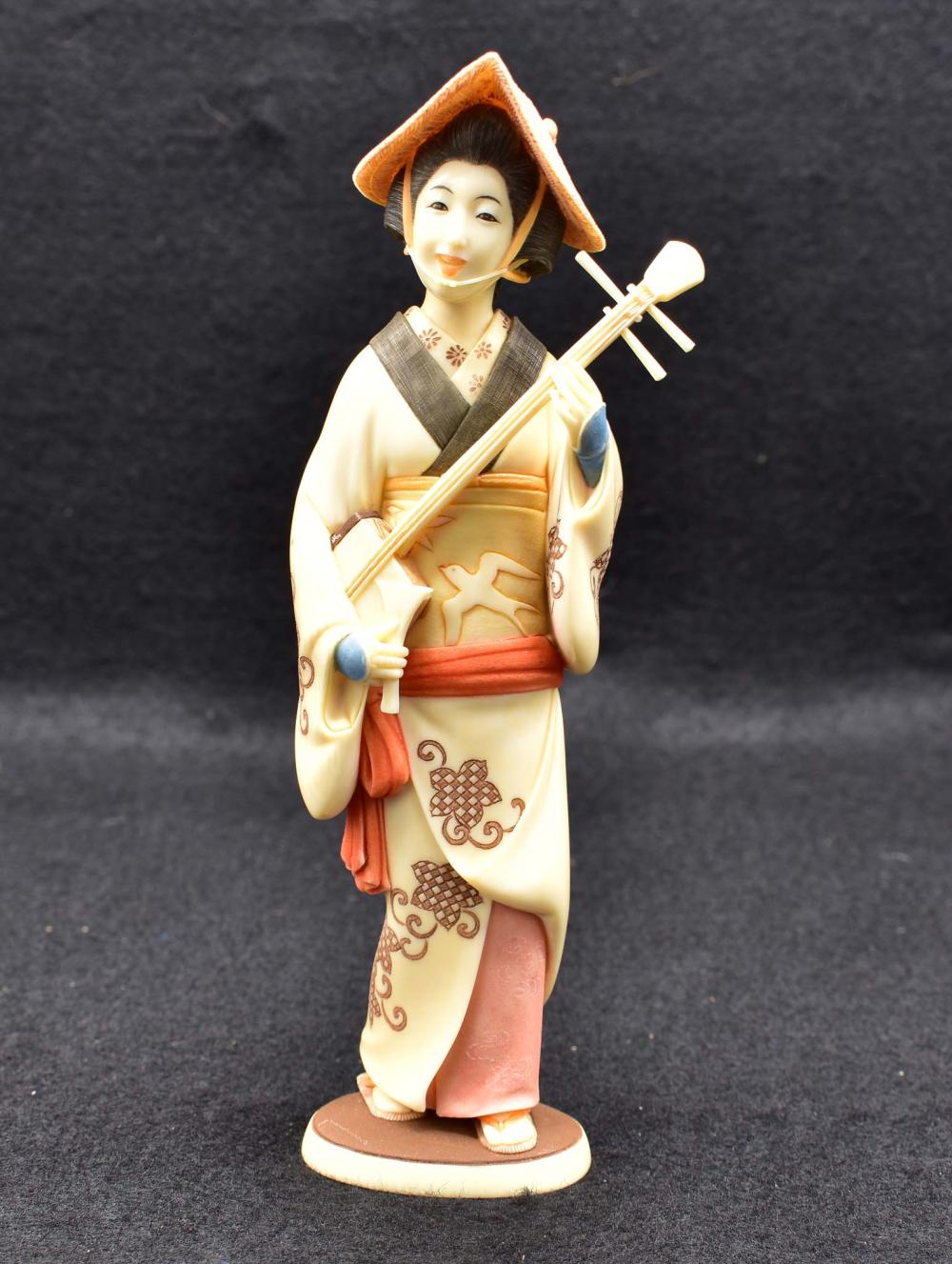 Appraisal: JAPANESE POLYCHROME OKIMONO OF GEISHASigned Meiji Period Wearing a kimono