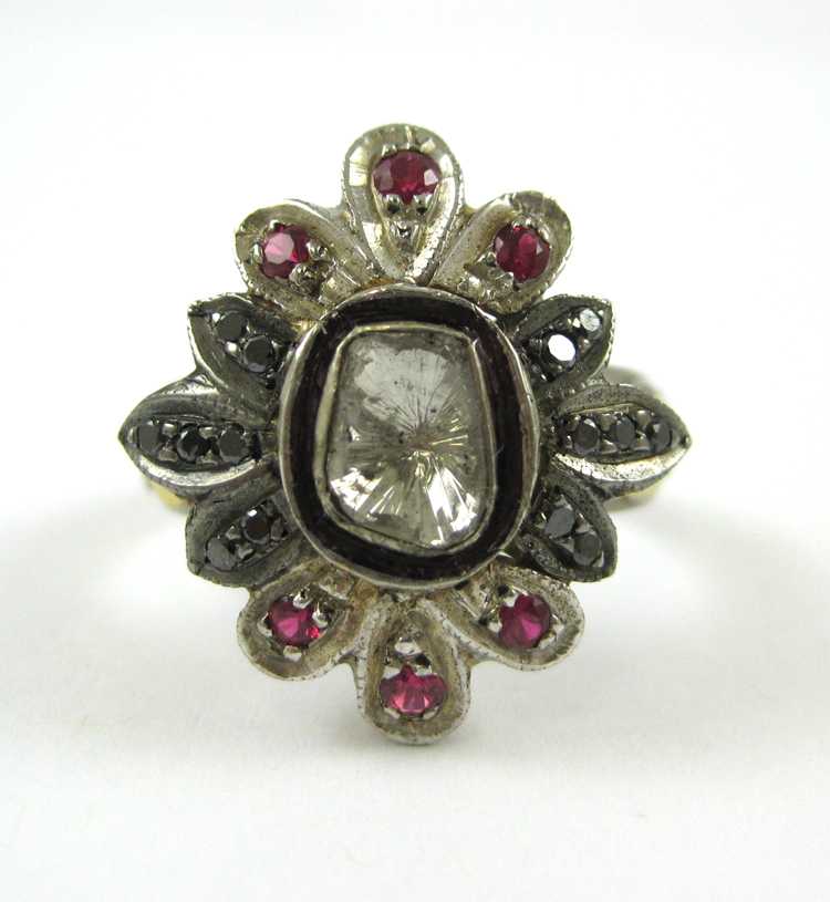 Appraisal: DIAMOND RUBY SILVER AND GOLD RING The sterling silver and