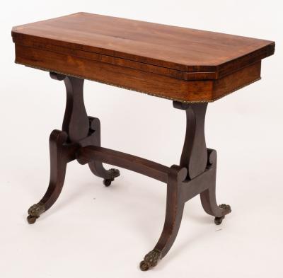 Appraisal: A Regency rosewood card table the cross banded top lined