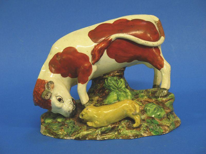 Appraisal: A STAFFORDSHIRE POTTERY BULL BAITING GROUP th century modelled as