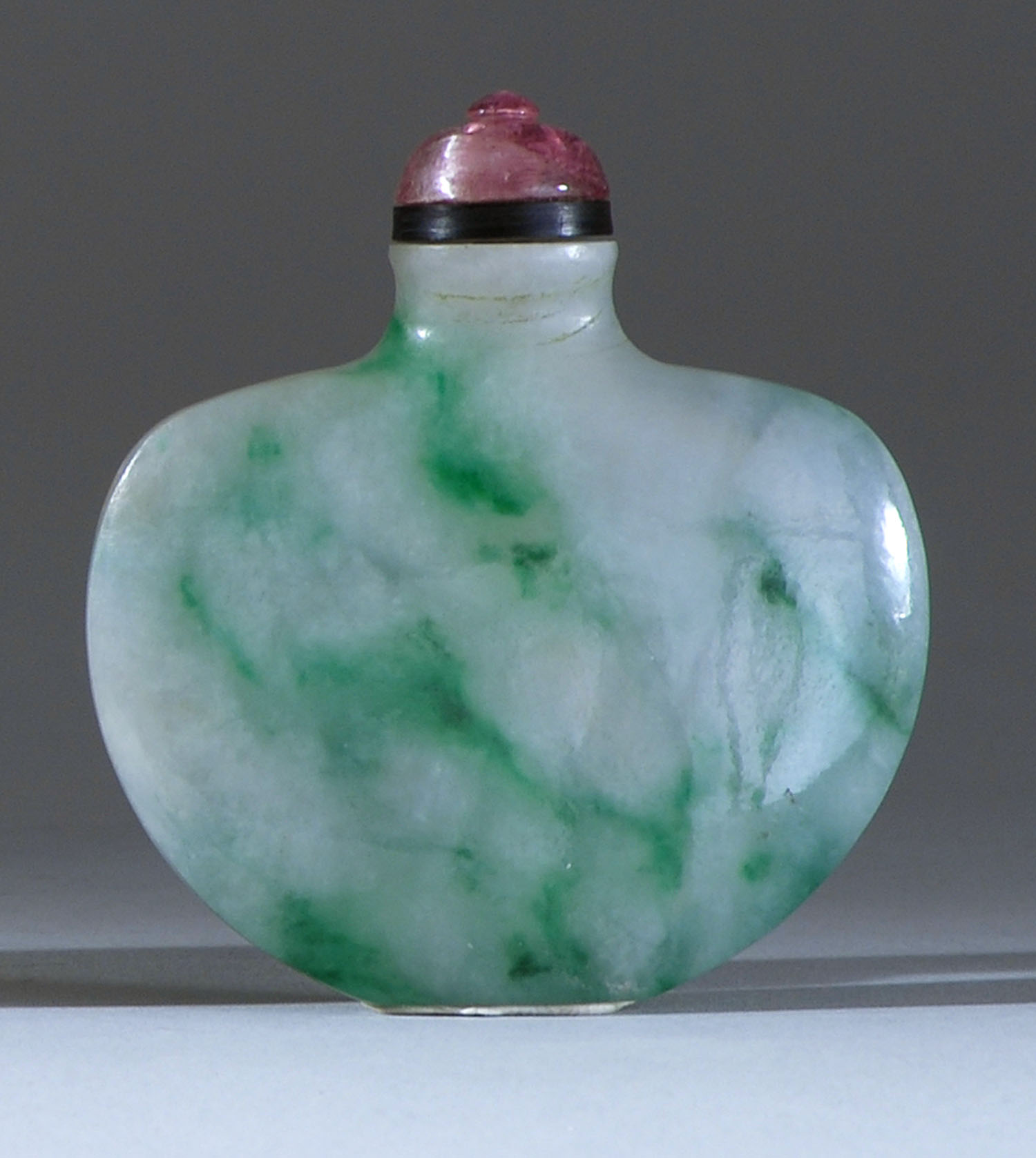 Appraisal: GREEN AND WHITE JADE SNUFF BOTTLE Late th CenturyIn purse