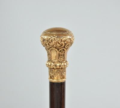 Appraisal: A Walking Stick with Decorative Knob A rosewood cane with