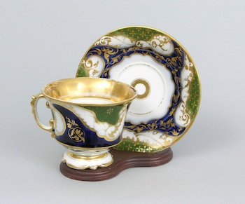 Appraisal: A Large Porcelain Tea Cup with a Saucer The cup