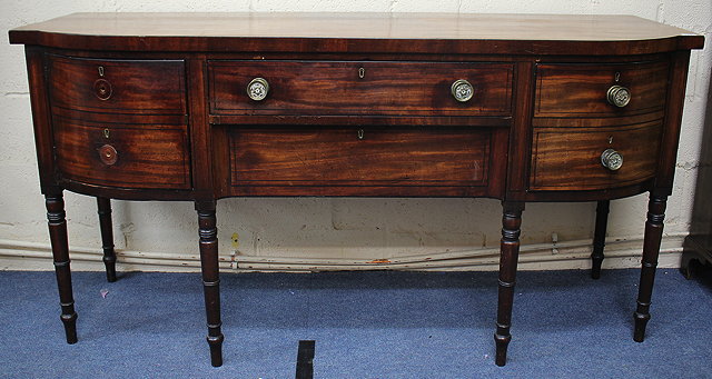 Appraisal: A GEORGE III MAHOGANY BOW FRONTED SIDEBOARD with ebony stringing