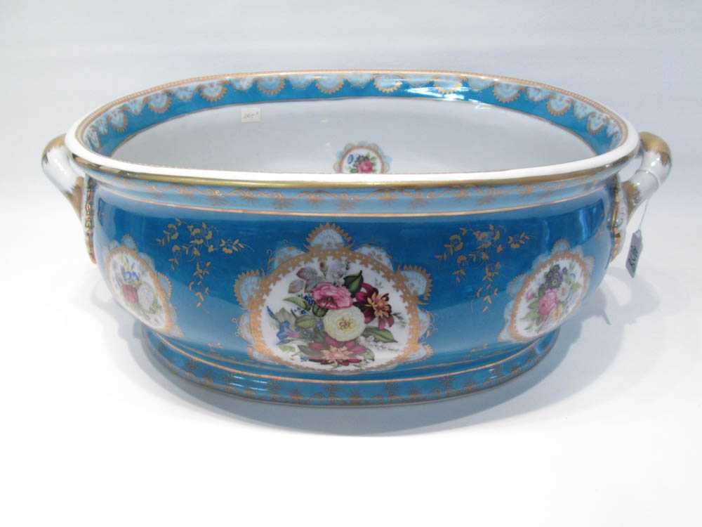 Appraisal: PORCELAIN OVAL WINE COOLER split handled with floral transfer cartouches