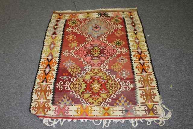 Appraisal: A KELIM WOOL CARPET with polychrome decoration in running borders