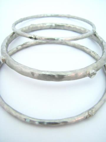 Appraisal: Three hammered sterling silver bangle bracelets by Rhonda Faber Green