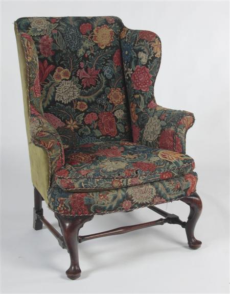 Appraisal: A mid th century mahogany framed wing armchair the shaped