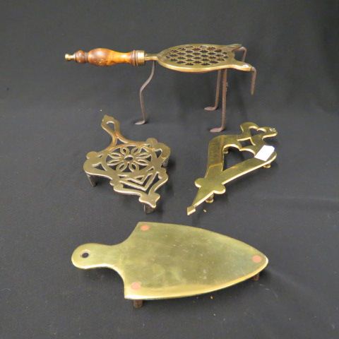 Appraisal: Brass Figural Trivets and a Kettle Stand th century