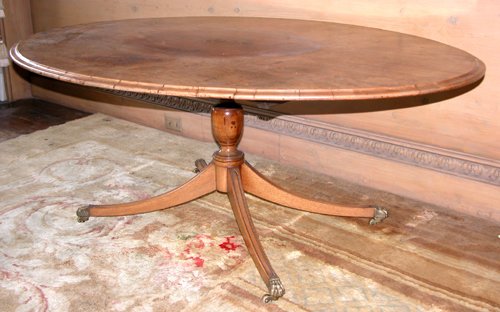 Appraisal: Title Mahogany Coffee Table with oval shaped top and tetrapod