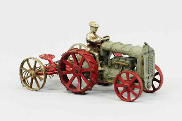 Appraisal: FORDSON TRACTOR AND HAY RAKE Arcade cast iron grey painted