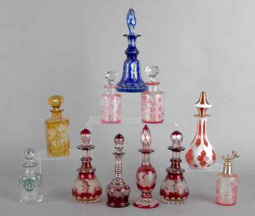 Appraisal: Eleven colored glass scent bottles etched overlay and flash decoration