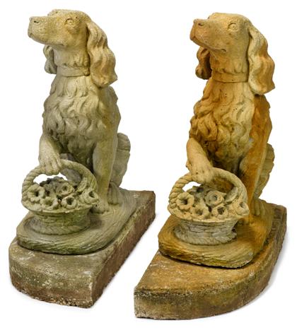 Appraisal: Pair of cast stone dogsEach with a front paw resting