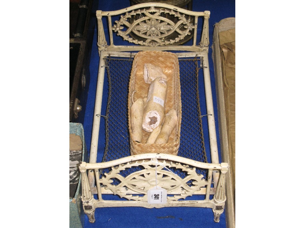 Appraisal: Lot comprising wrought iron doll's bed and an antique doll