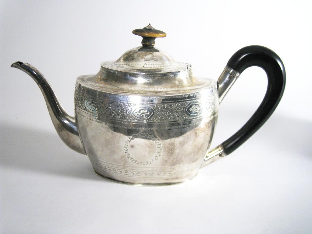 Appraisal: A George III oval Teapot with bright cut fruiting oak