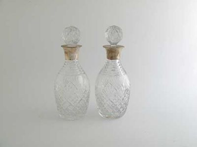 Appraisal: Two modern mounted cut glass decanters with oviform bodies by