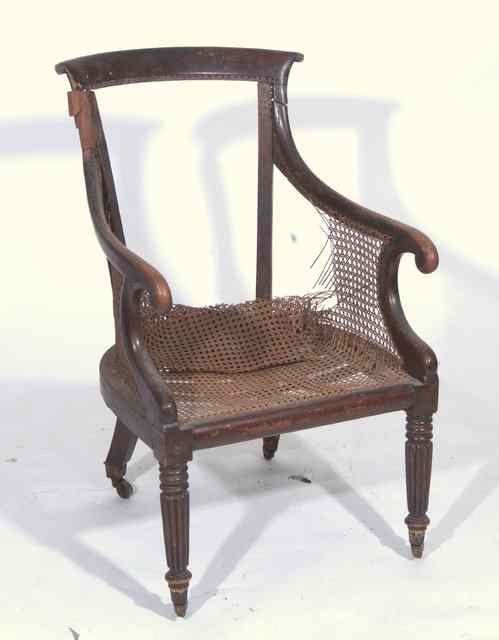 Appraisal: A TH CENTURY FAUX ROSEWOOD BERGERE ARMCHAIR with scrolling arms