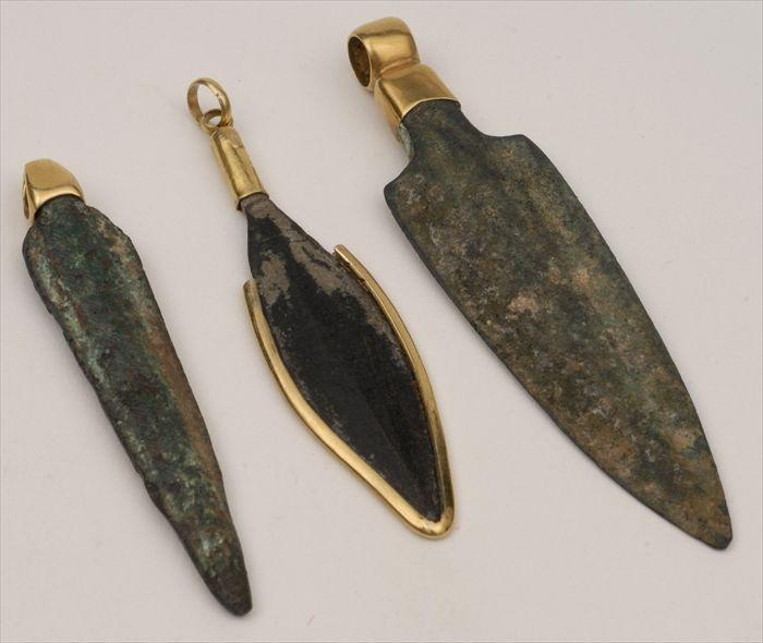 Appraisal: THREE BRONZE LEAF-SHAPED SPEARHEADS MOUNTED AS PENDANTS The largest in