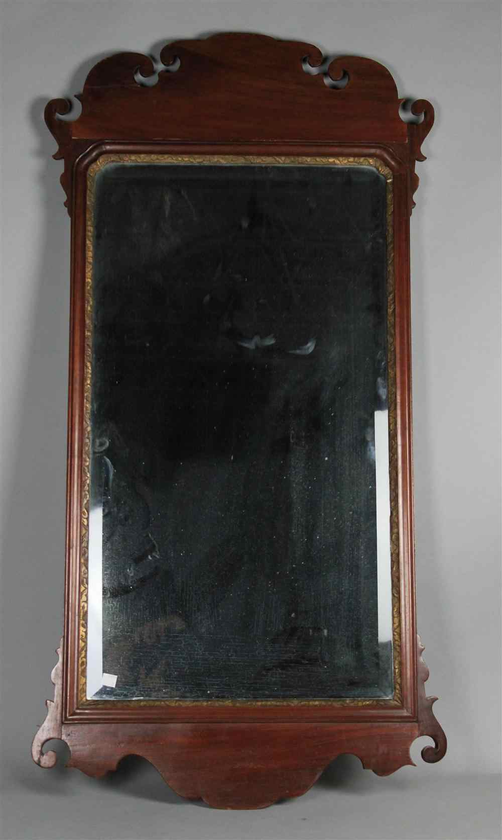 Appraisal: CHIPPENDALE STYLE MAHOGANY MIRROR with shaped veneered mahogany crest and