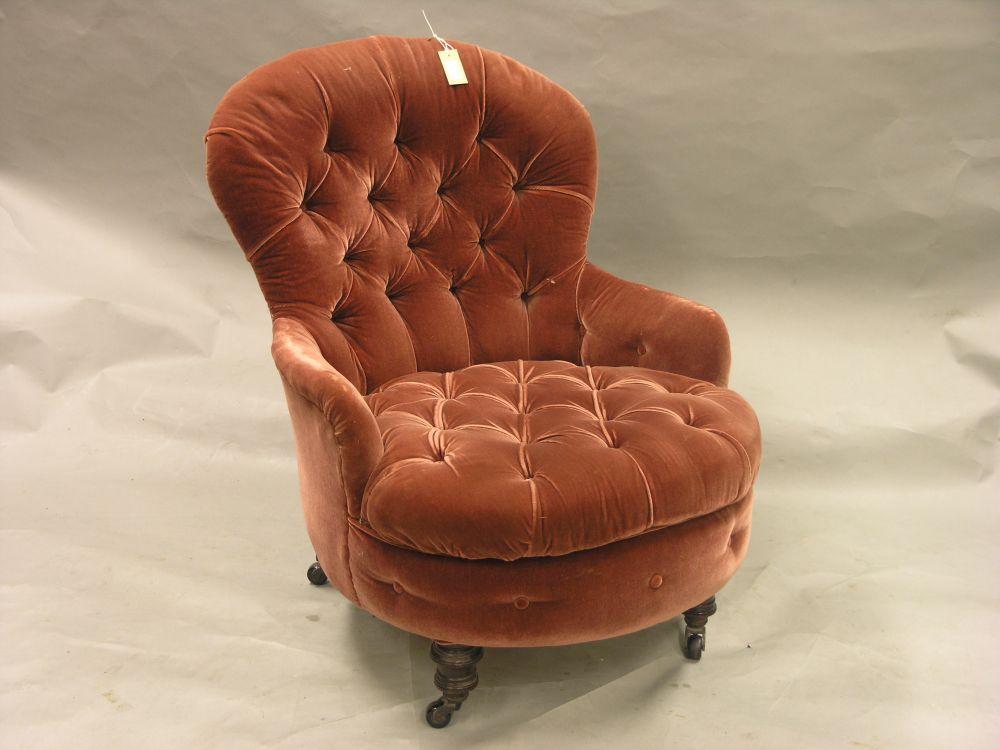 Appraisal: A Victorian walnut framed salon armchair upholstered in a buttoned