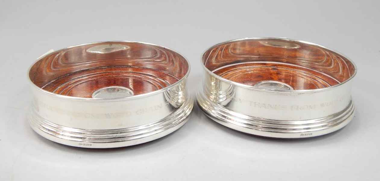 Appraisal: A modern pair of silver wine coasters each with a