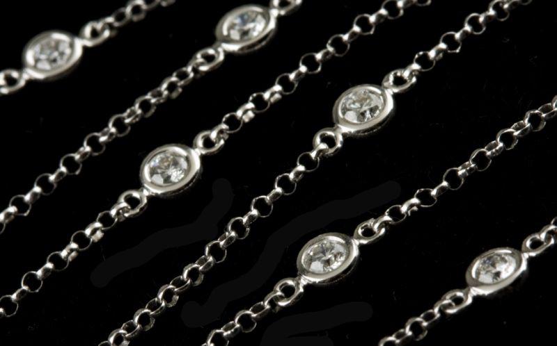 Appraisal: KT White Gold and Diamond Station Necklace with stations each